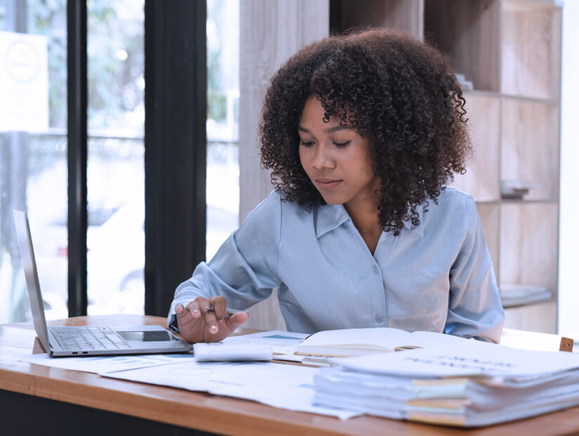 business woman calculating taxes while working from home