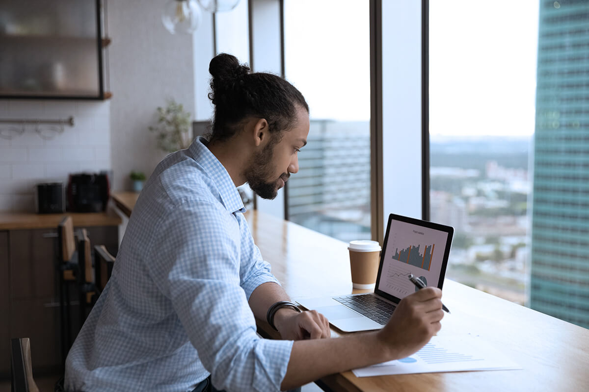 focused black male remote working on laptop 1