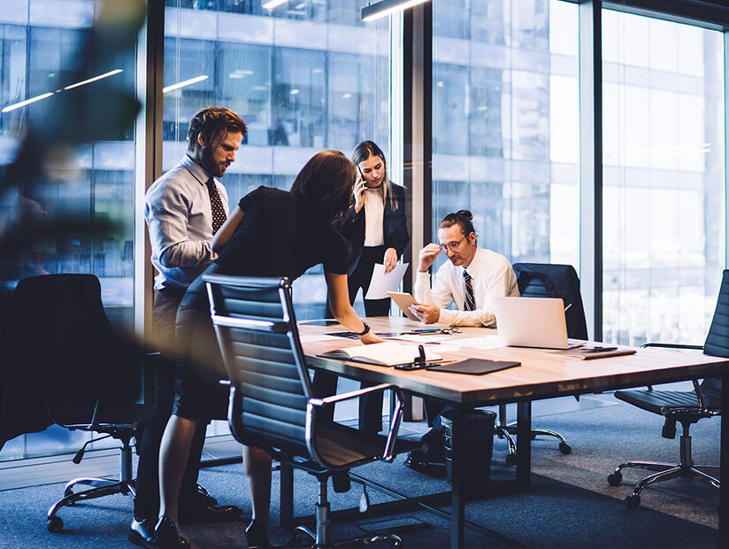 team of four collaborating at a conference table