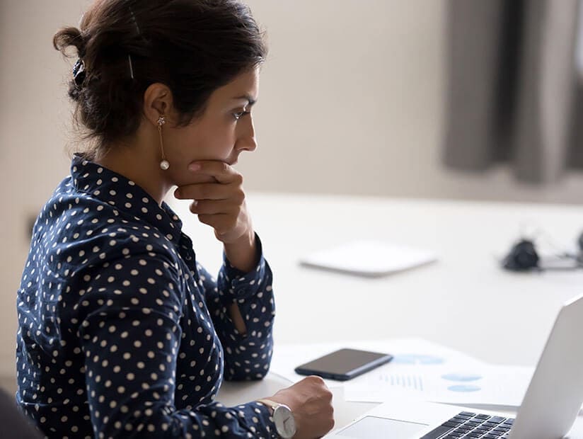 accountant professional woman sitting at desk thinking