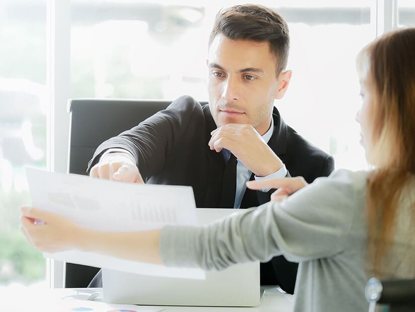 cfo reviewing financial summary reports with colleague