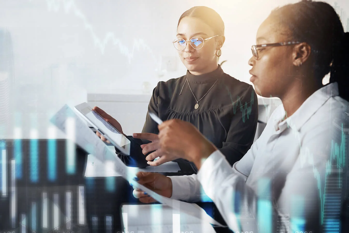 Two-women-discuss-financial-planning-analysis-documents