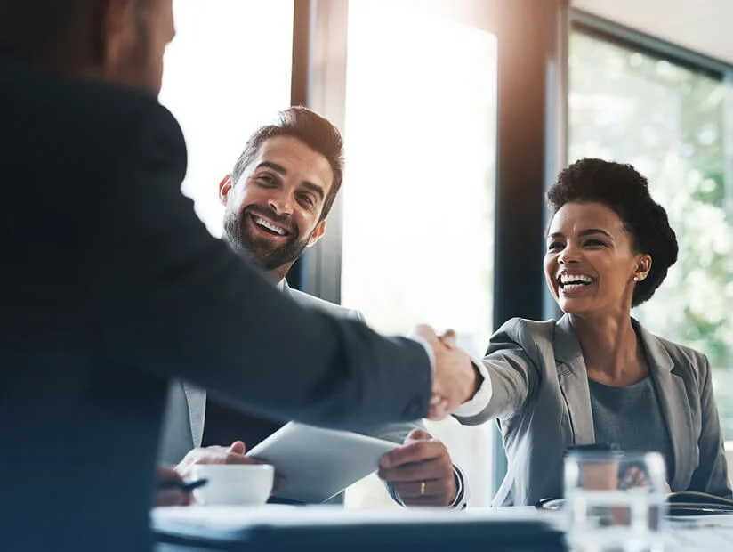 Chapter 05 - Upskilling & Reskilling in the Age of AI 8 three business people at table in agreement 2