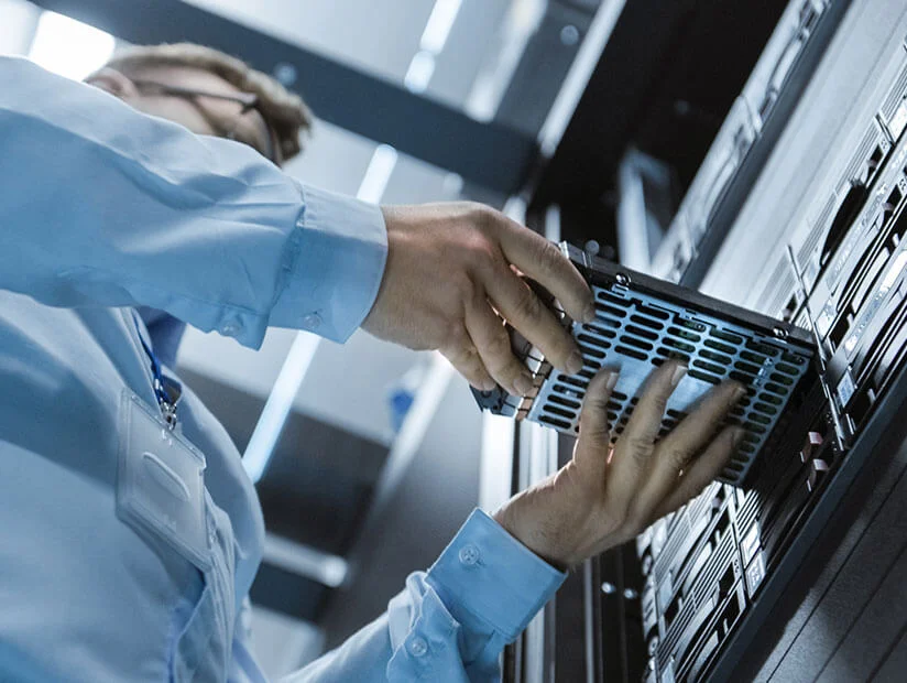 Tech and AI Consulting Services 27 man inserting drive into server 1
