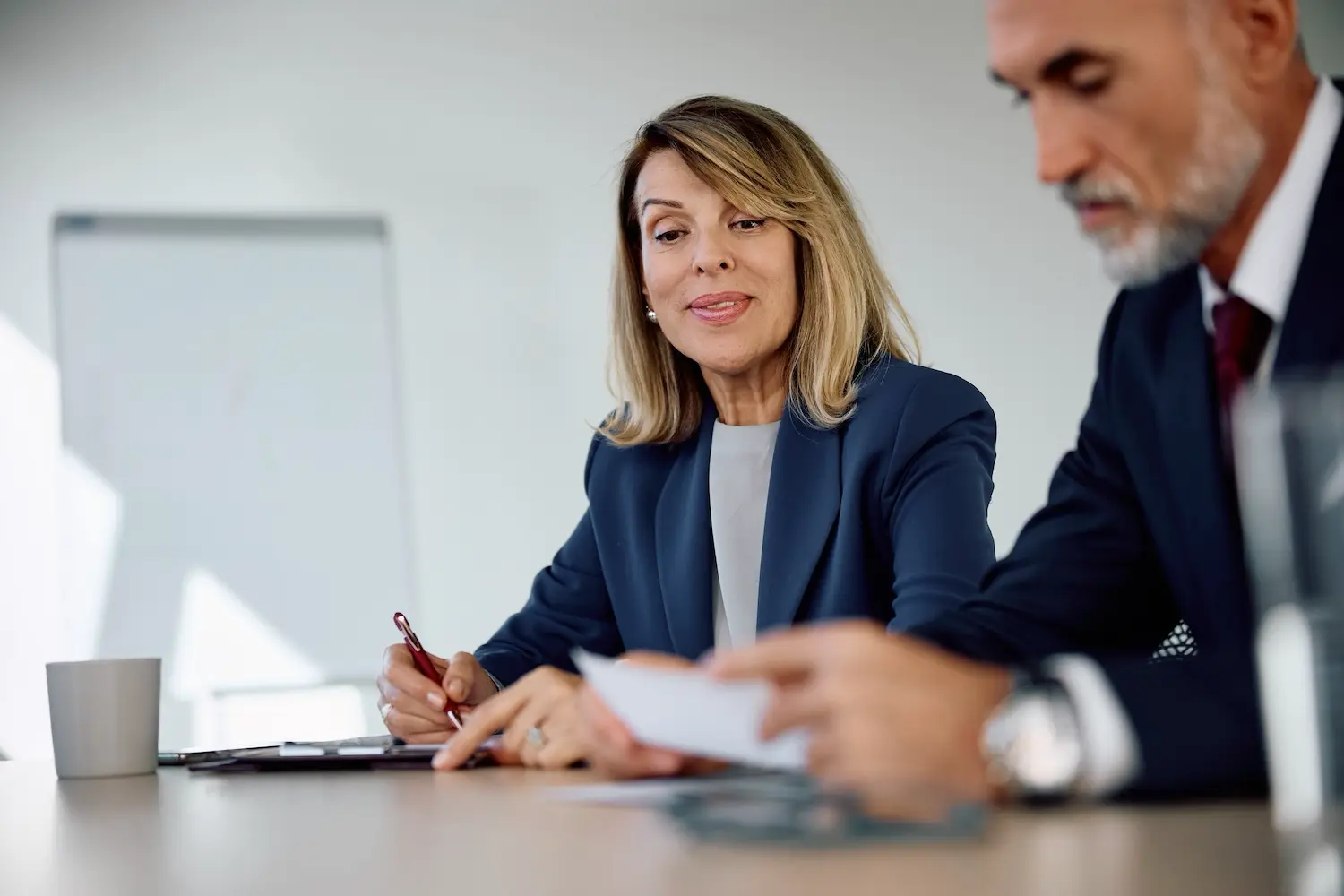 Small business owner discusses with her tax advisor the process for switching her company to an S corporation
