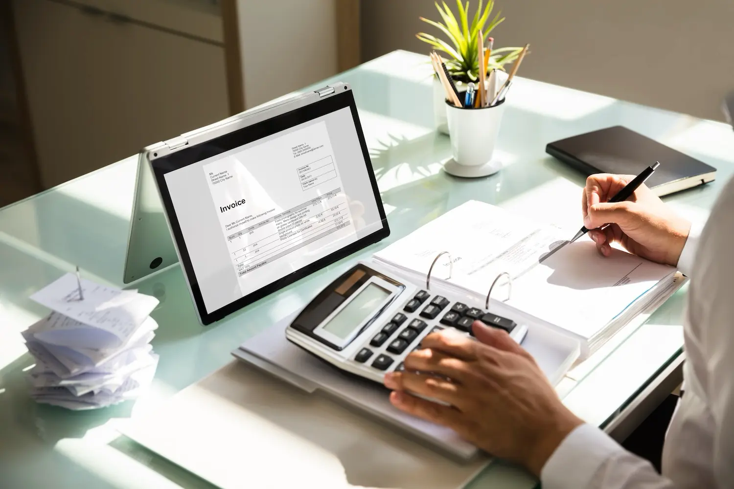 A small business owner reviews their invoices for factoring A small business owner reviews their invoices for factoring
