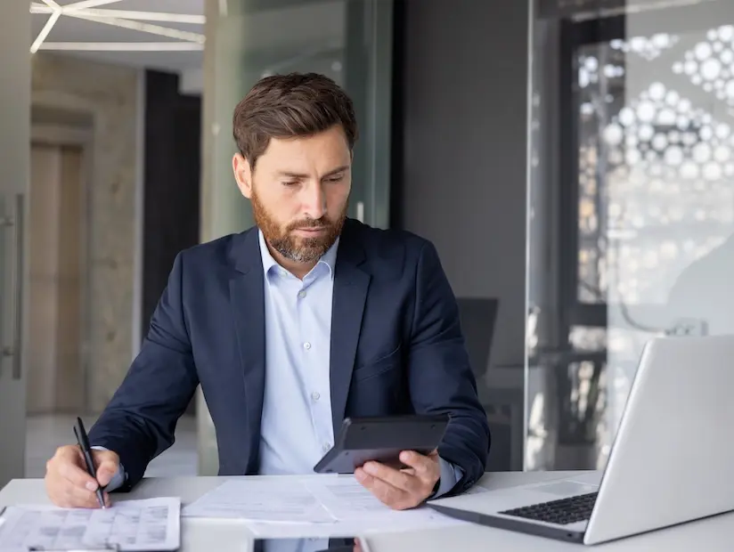 Tax accountant works on calculator